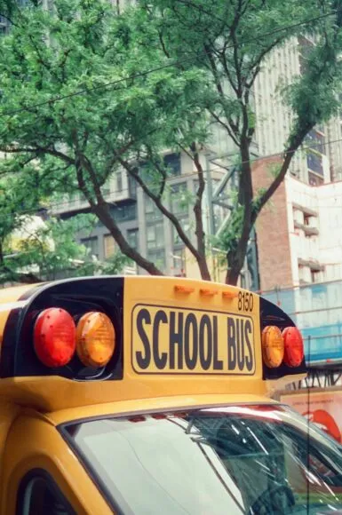A school bus is parked in the city.