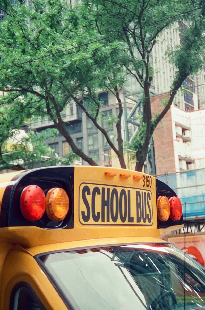 A school bus is parked in the city.