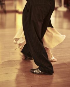 Couple dancing ballroom on a wooden floor